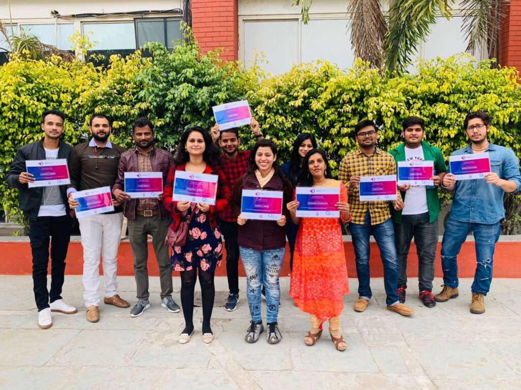 students standing in a line with the certificate in their hands, received after they complete the digital marketing with Digitrend.